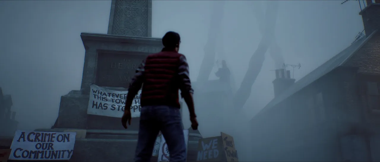 A man seen from behind facing a stone monument in fog, with handwritten protest signs at its base.