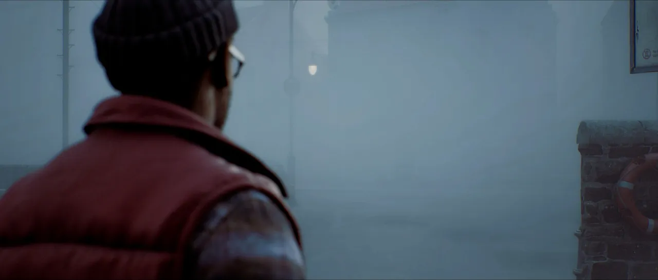 Over-the-shoulder view of a man in a red vest looking down a street into thick fog.