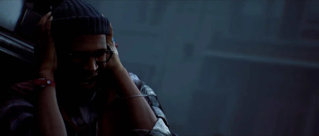 A man in a knit hat holding his head in his hands.