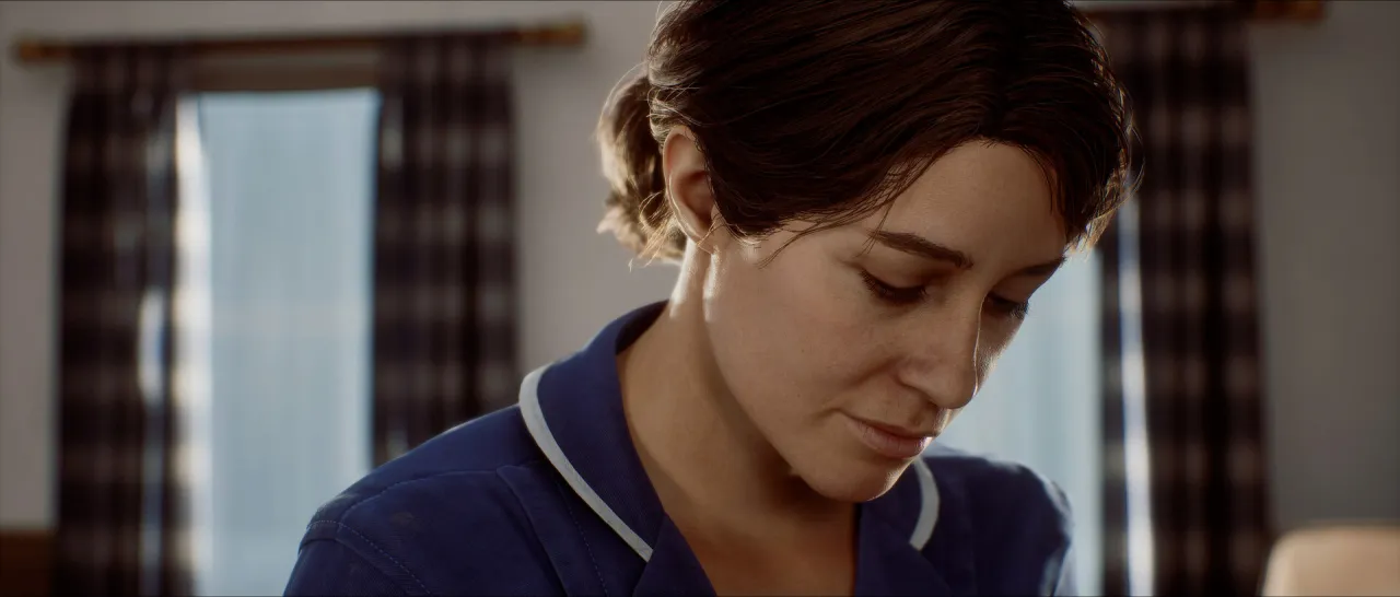 A woman in a blue uniform looking down, with checked curtains behind her.